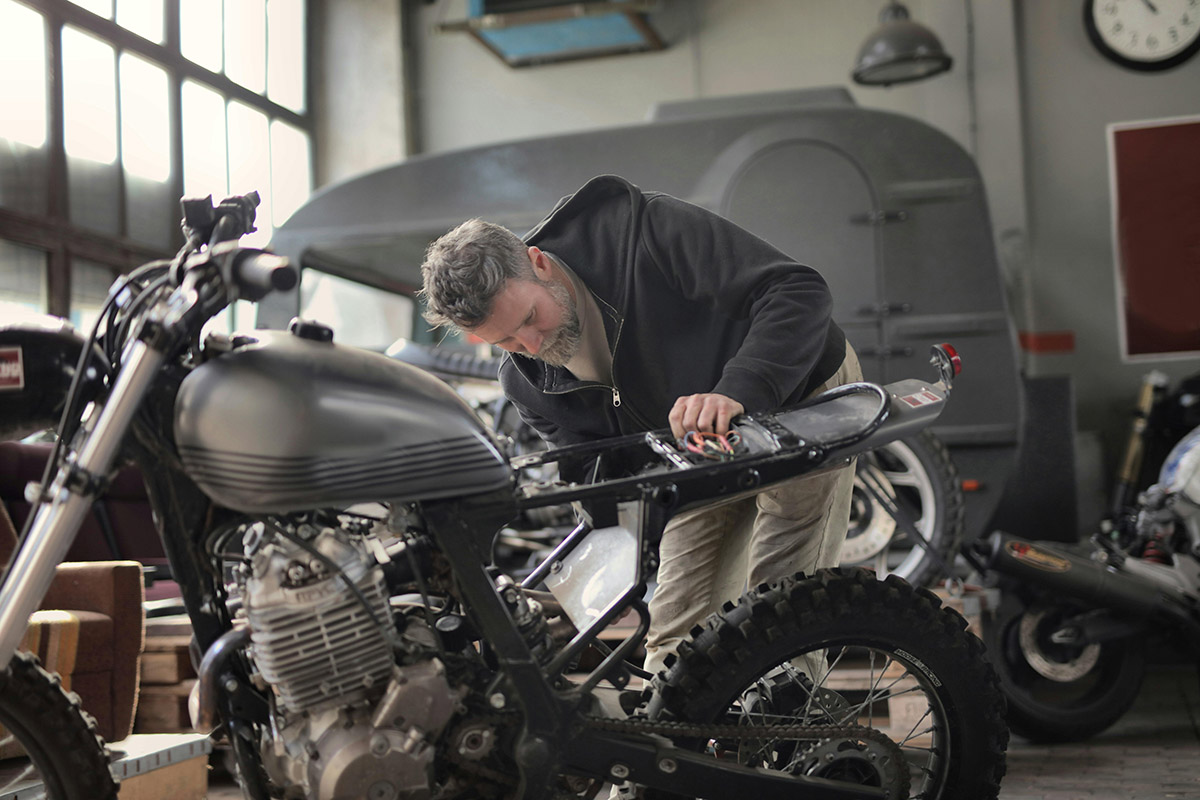 Man Inspecting a Motorcycle